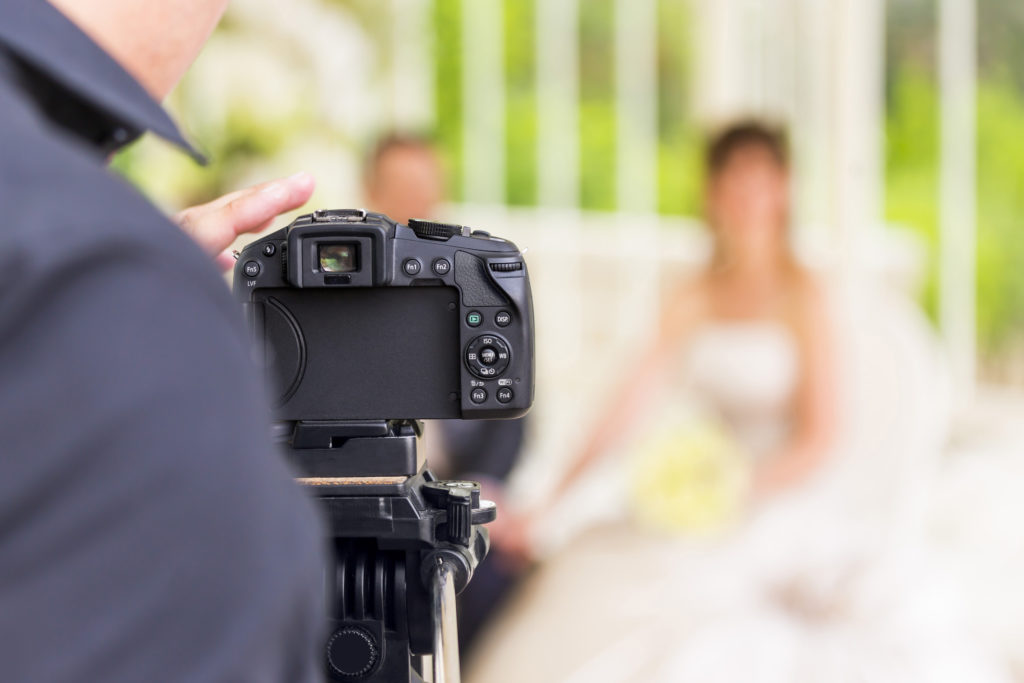 wedding photographer and blurred marriageable couple